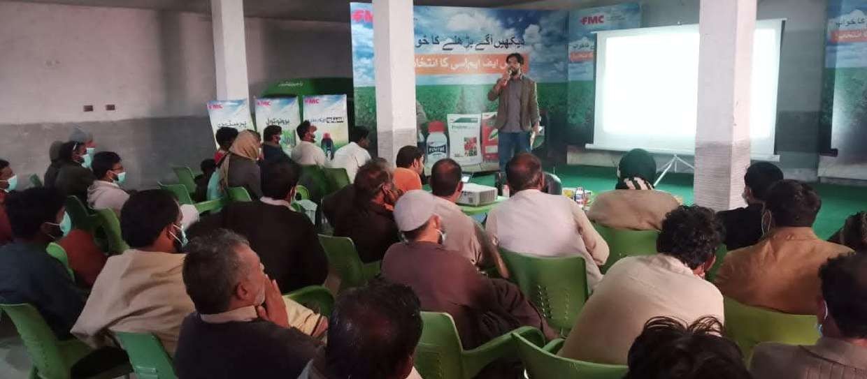 Farmer training event with agricultural input company banners