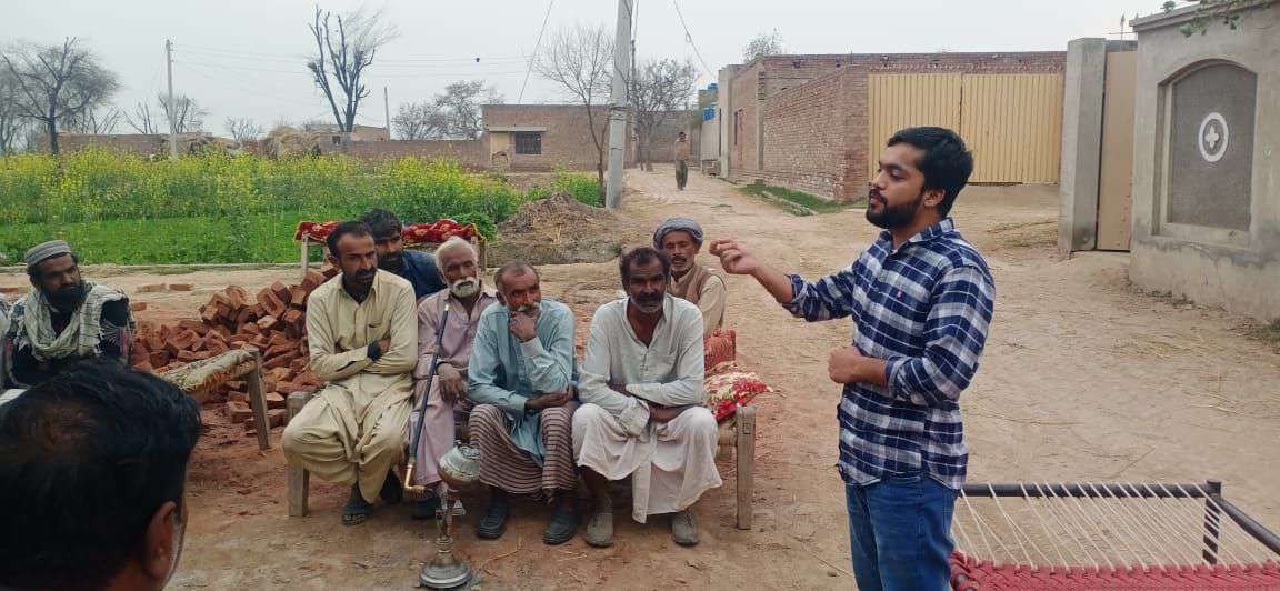 Meeting with farmers in a village setting
